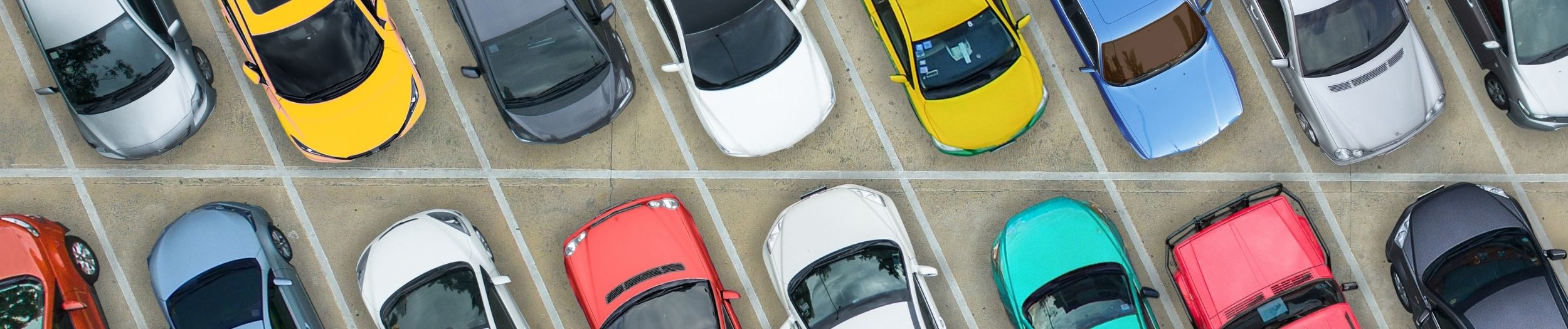 Aerial View of a Range of Cars in a Car Park