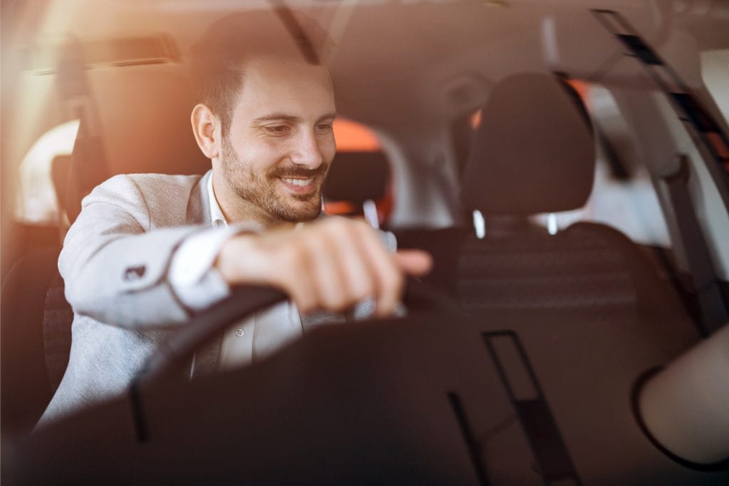 Man behind the wheel of a car