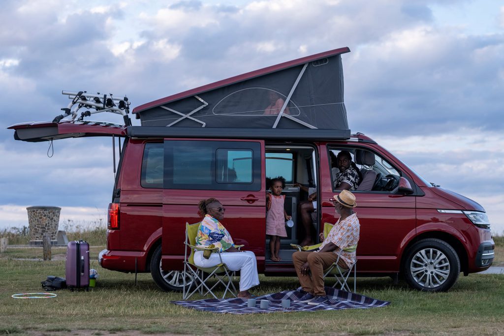 family sat with campervan