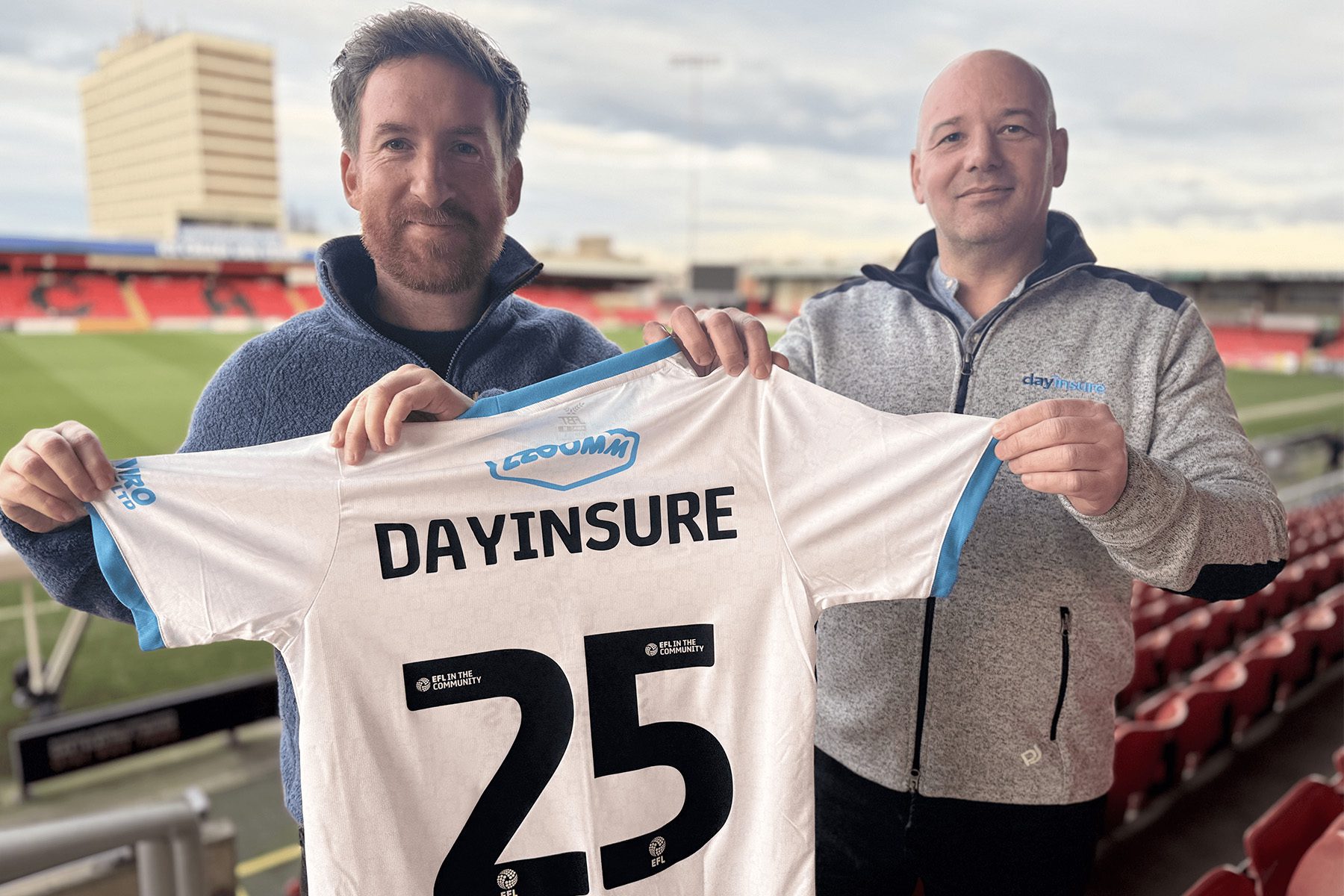 Dayinsure colleagues holding a Crewe Alex Football shirt